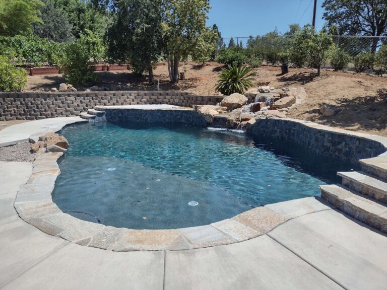 freeform pool with natural rock waterfall
