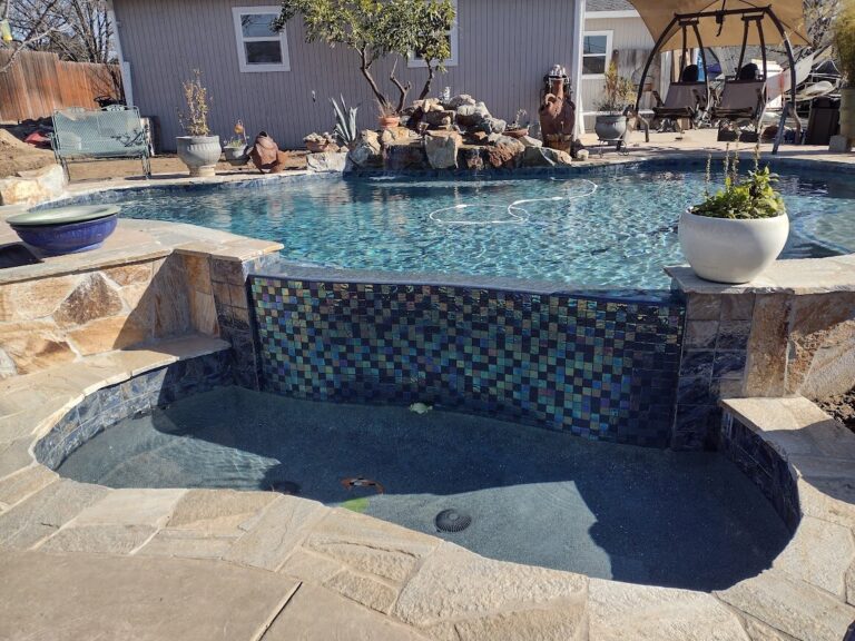 Pool with rock decor and tiled waterfall